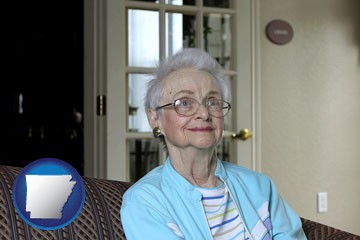 a senior woman in an assisted living facility - with Arkansas icon