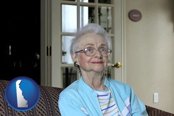 a senior woman in an assisted living facility - with Delaware icon