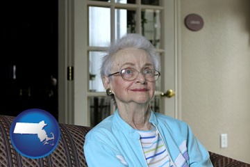 a senior woman in an assisted living facility - with Massachusetts icon