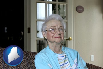 a senior woman in an assisted living facility - with Maine icon