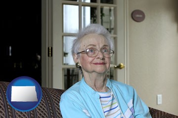 a senior woman in an assisted living facility - with North Dakota icon